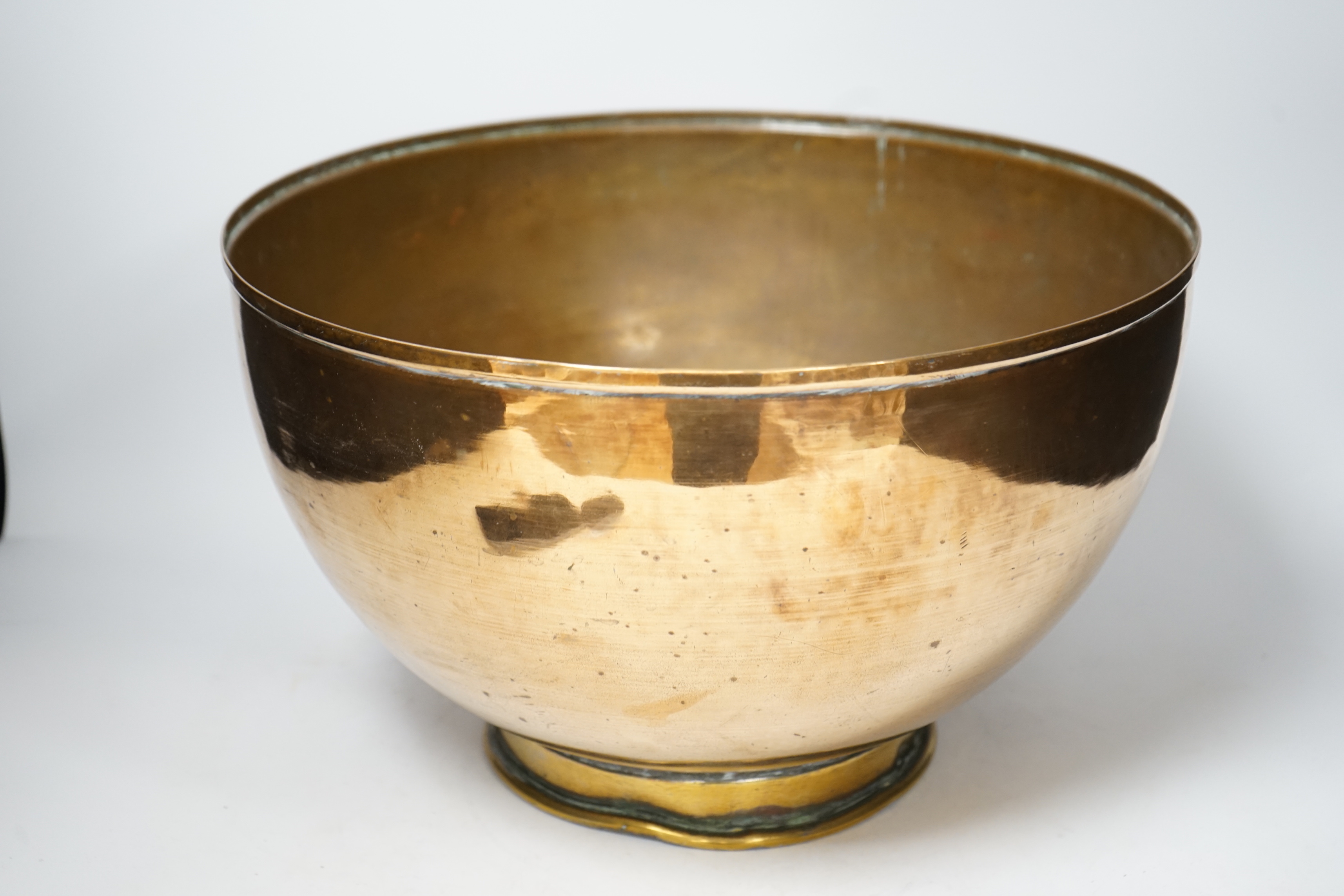 A large copper bowl with brass foot rim, 39cm diameter